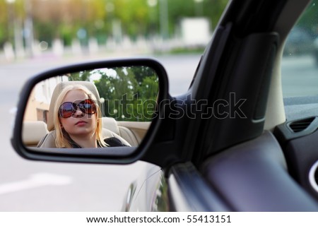 Pretty Woman Driving Her Convertible Sports Car With Her Sunglasses