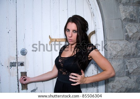 Young woman pulls at church door