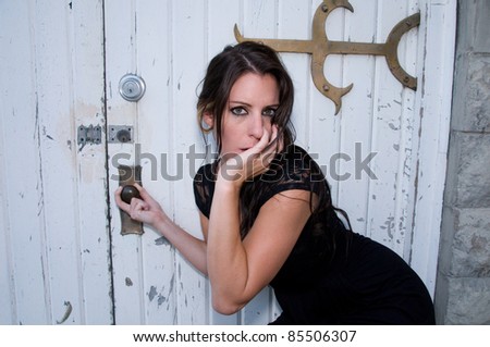 Young woman pulls at church door