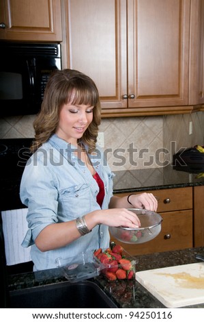 Young woman packs strawberries
