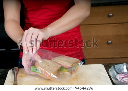 woman packing sandwiches