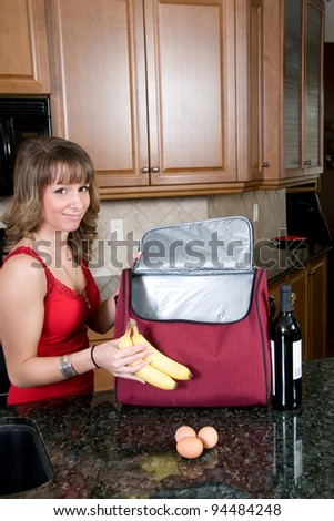 Young Woman Packing Picnic Hamper