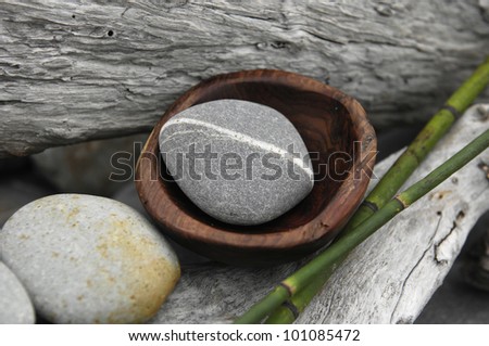 Bowl of stone with thin bamboo grove on old wood
