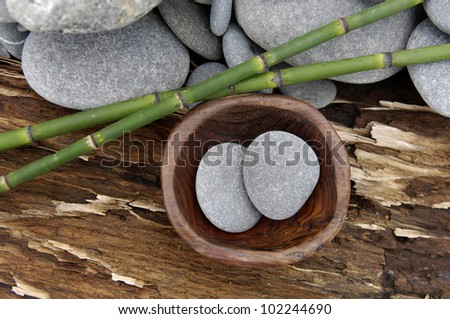 Pile of stones with thin bamboo grove on old wood
