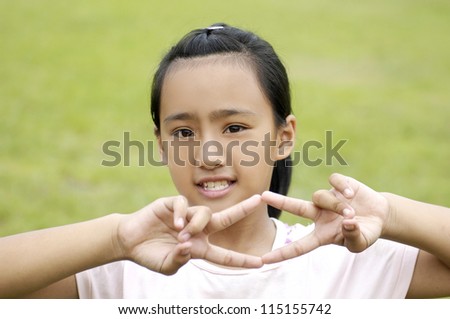 Adorable girl little showing two victory sign
