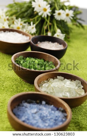 Set of Sea salt in bowl, rose with branch daisy flower on green soft