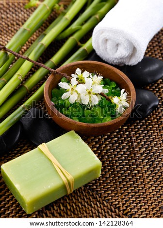 salt in bowl with grove, soap ,towel, flower in spa setting
