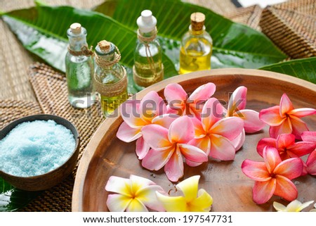 candle ,flower soap on green palm leaf