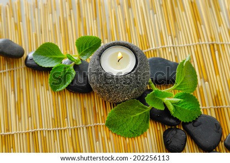 Green leaf and row of stone with candle mat texture