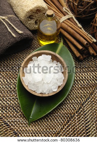 Spa aroma bowl of salt with towel with massage oil and incense on burlap mat