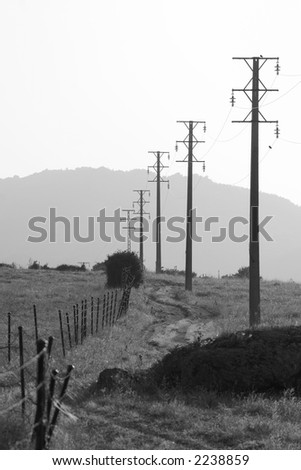 Black and white landscape on an old power lines near a mountain massif