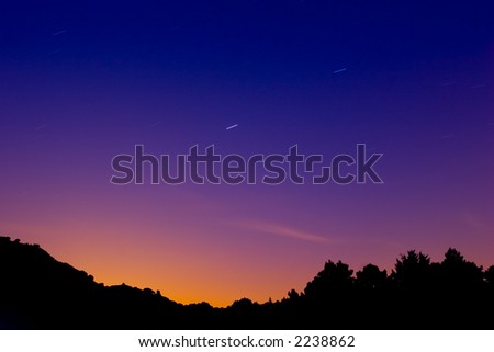 Very saturated landscape with star trails due to the rotation of the earth