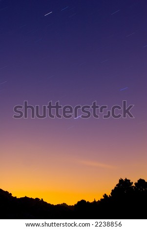 Very saturated landscape with star trails due to the rotation of the earth