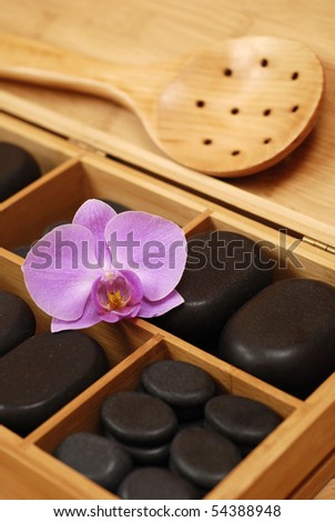 box with stones for massage and with orchid