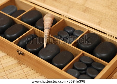box with stones for massage and with shell