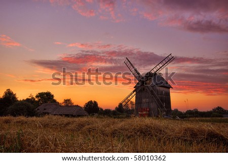country landscape with the windmill at sunrise