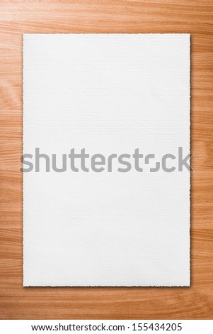 White page of paper on the wooden background