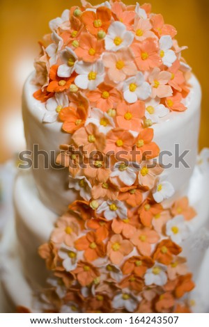 Wedding orange cake with flowers and candles