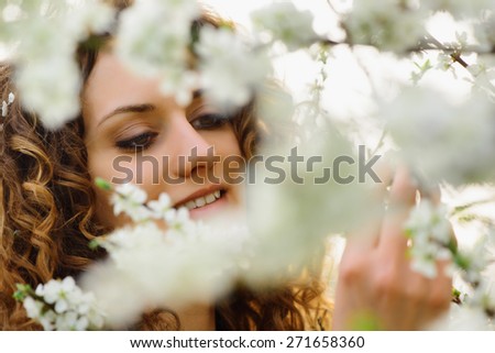 portrait of beautiful young woman with cherry blossom