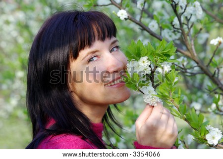 Beautiful woman at the plum-tree