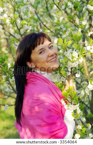 Beautiful woman at the plum-tree