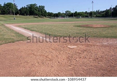 A unoccupied baseball field, shot from behind home plate.