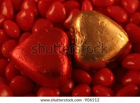 Red and Gold Foil wrapped chocolate hearts set against cinnamon hearts.