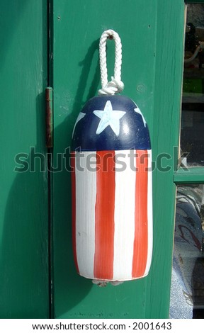 A souvenir buoy painted with an American flag theme.
