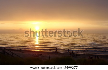 A beautiful sunset with people silhouetted, shot at Lake Huron in the Pinery.