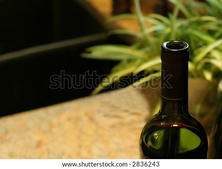 A freshly opened bottle of wine, sitting in the kitchen.