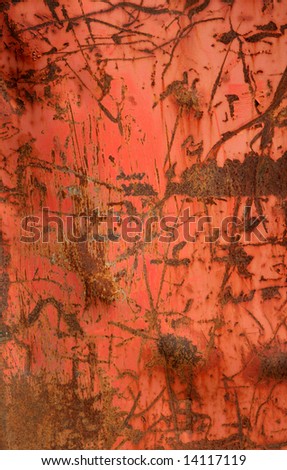 A red metal container with rusted scratches.