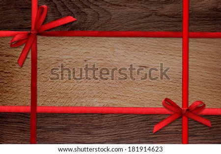 wooden surface with red ribbons as background