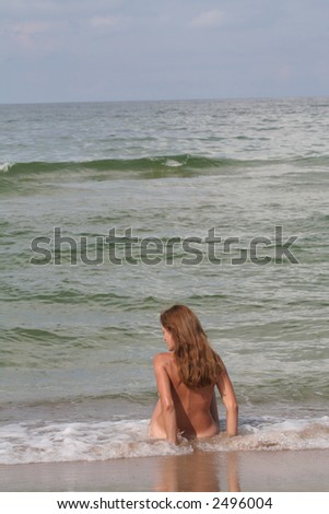 A woman sitting in the waving sea