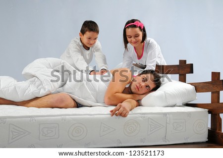Children wake up father in bed
