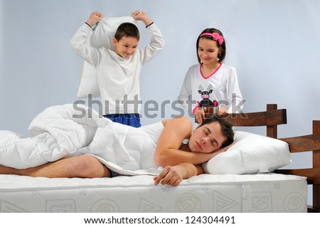 Children wake up father in bed