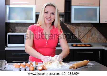 young baking woman forming dough with her hands