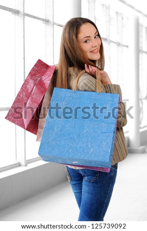 portrait of a young girl with bags for shopping
