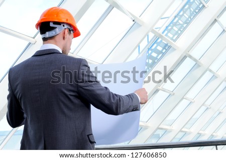architect looking comparing housing project with building
