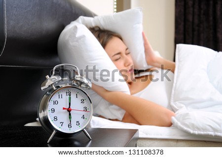 Young woman getting stressed about waking up too early