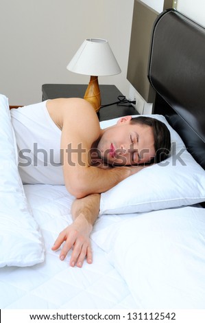 portrait of a young man sleeping on the bed