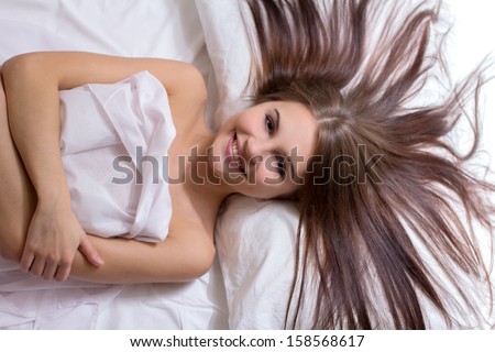 Sleeping beauty. Top view of beautiful young woman lying on the bed