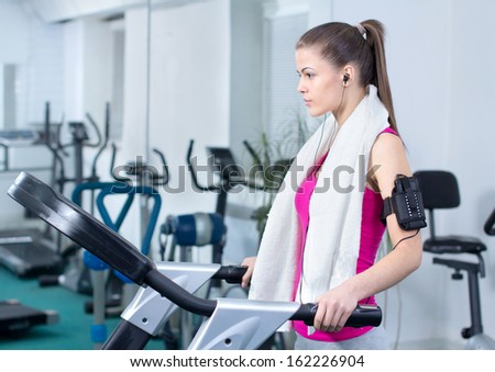 Fitness Woman. Woman runs on a treadmill, exercise in the sport club