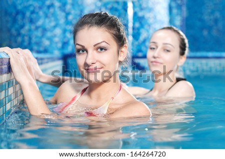Spa & Wellness. young women relaxing in outdoor jacuzzi by the pool