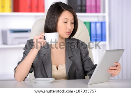 Business woman Asia. drinking tea or coffee and work in his office.