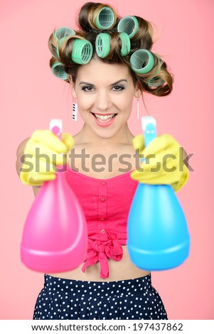 Funny housewife with rag. wipe and cleaning spray for window. Foam soap on glass