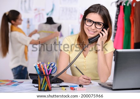 Portrait of a young woman, designer clothing, while working in his office