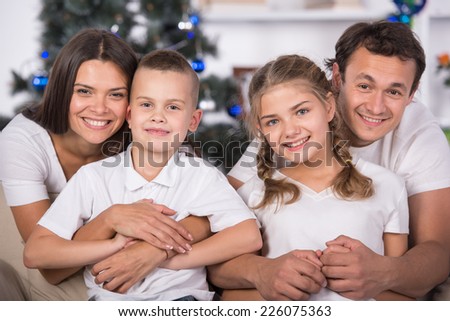 Portrait of friendly family are looking at camera on Christmas evening.