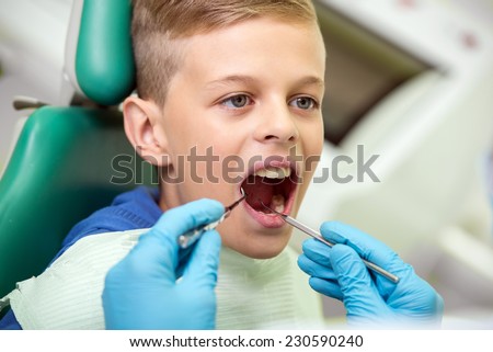 Portrait of little boy during inspection of oral cavity.