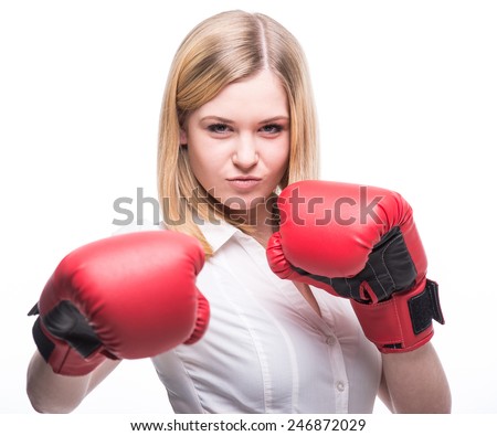 Business woman is wearing boxing gloves and business suit on the white background.
