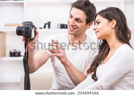 Young couple are using pc tablet to looking at photographs.